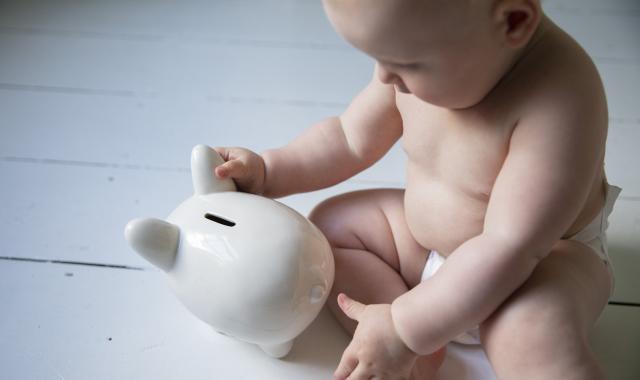 baby with piggy bank