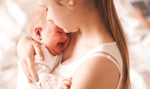 Mother holding crying baby