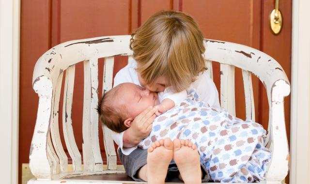 toddler with baby