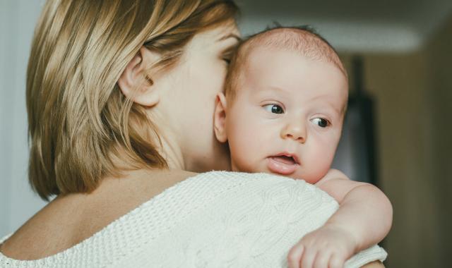 A mother holds her young baby.