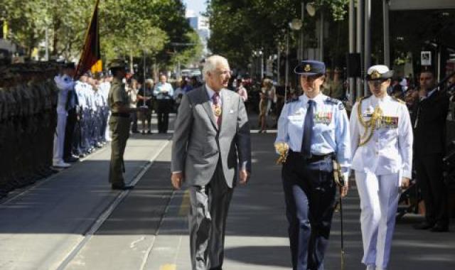 Wing Commander Kelley Stewart, in the middle in blue, as Guard Commander of the Tri-Service Royal Guard of Honour at the official Australia Day Flag Raising Ceremony in Melbourne 2014. The Governor of Victoria, His Excellency, the Honourable Alex Chernov AC QC, is on her right