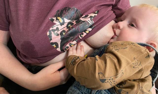 Mum feeding with leaking breast