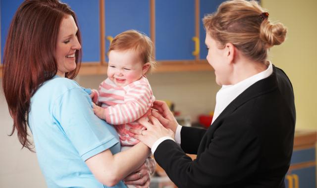 Mother dropping baby at childcare