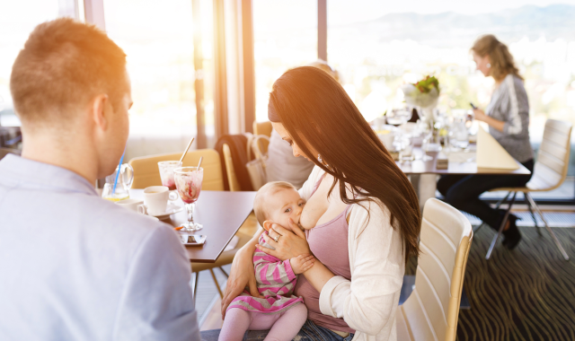 Mother breastfeeding in a restaurant 