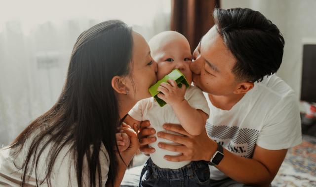 Two parents holding their baby