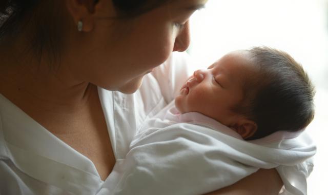mum looking up close at baby