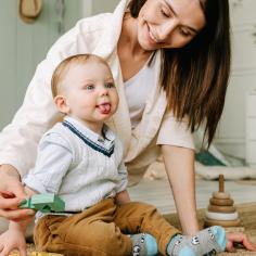 A woman smiles at her baby