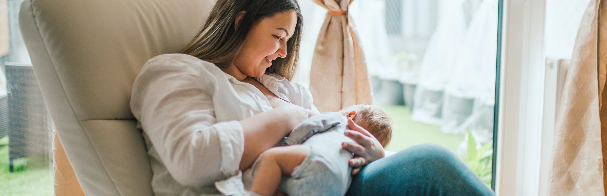 woman in armchair breastfeeding